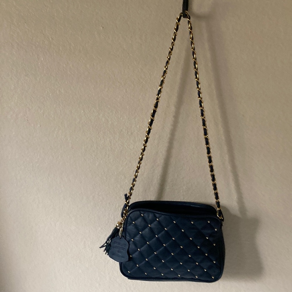 Genuine leather, funky-as-hell, small shoulder bag.